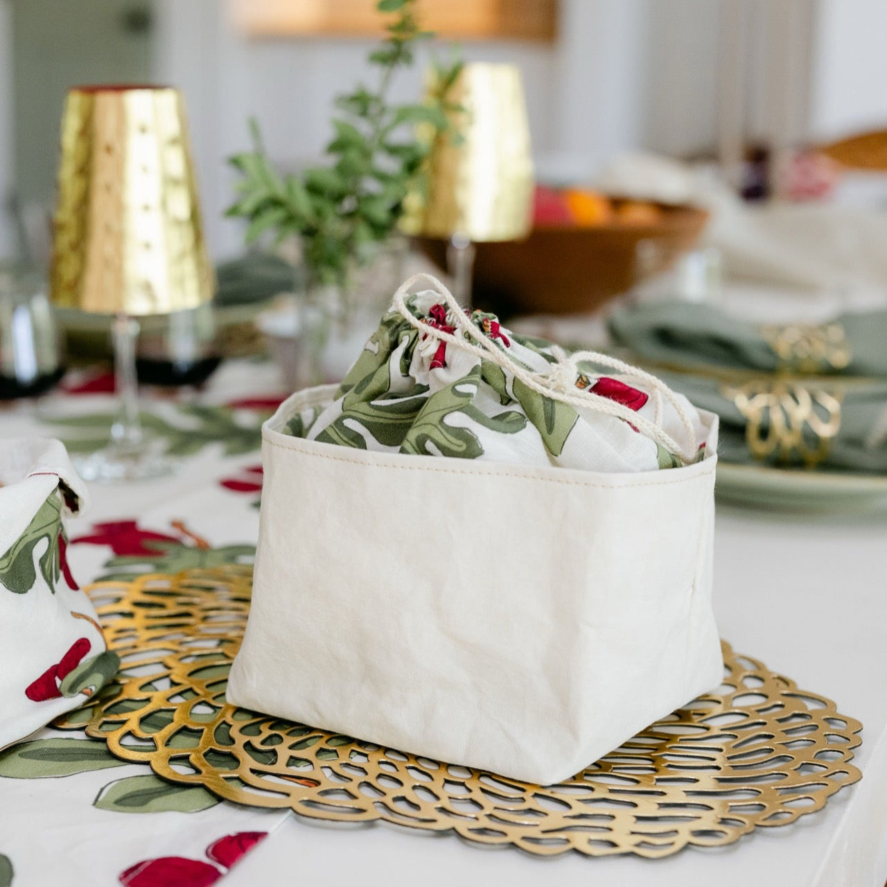 Decorative table setting with floral-patterned bowls on a tablecloth.