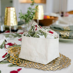 Decorative table setting with floral-patterned bowls on a tablecloth.