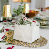 Decorative table setting with floral-patterned bowls on a tablecloth.