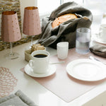 Café setting with coffee, plates, and lamps on a table.