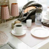 Café setting with coffee, plates, and lamps on a table.
