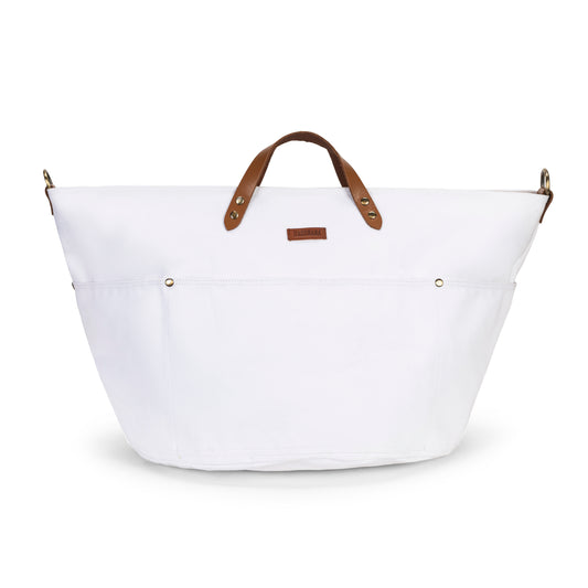 White cotton tote bag with tan leather short handles and exterior pockets