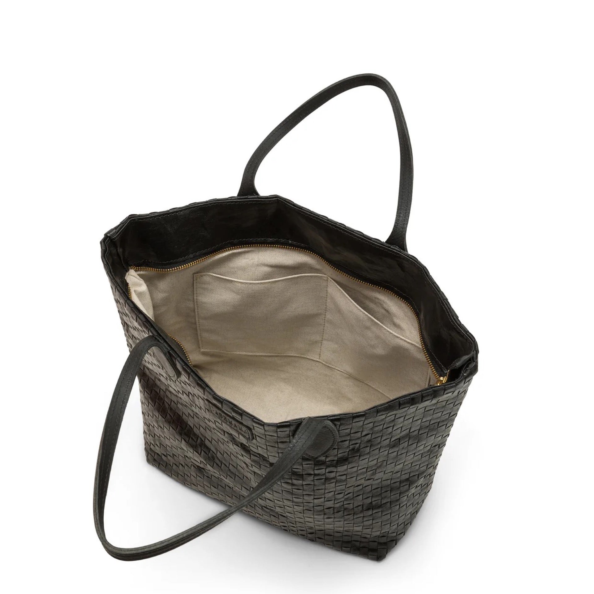Interior of small black woven handbag showing internal pockets