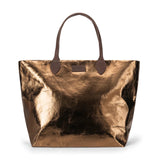 Bronze metallic tote bag with brown leather handles on a white background