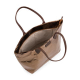 Interior of metallic bronze handbag showing internal pockets