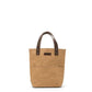 A brown washable paper tote bag with two short dark brown leather handles