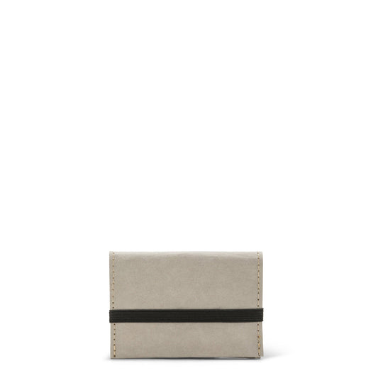 A pale grey washable paper card holder is shown from the front, with an elastic strap closure in black.