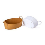 A tan washable paper storage basket sits at left, with a white washable paper basket shown on its side at right.