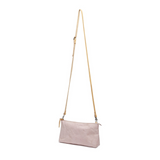 A pale pink washable paper small zip top handbag is shown with a long tan washable paper strap.