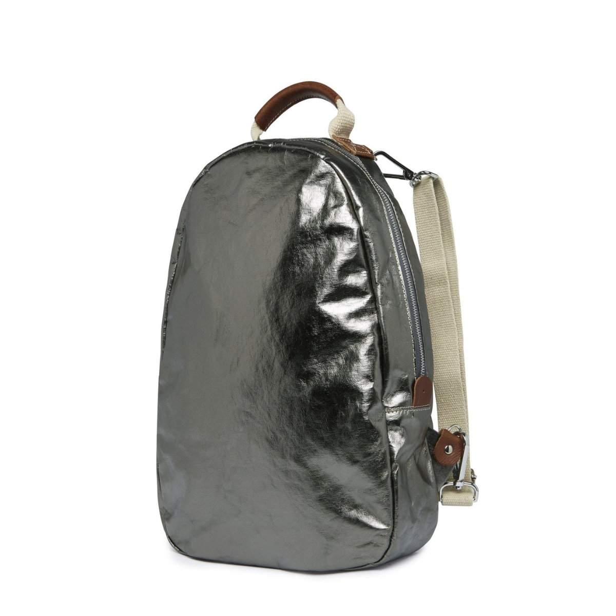 An oval washable paper backpack is shown from a 3/4 angle. It has a top handle, two adjustable canvas shoulder straps, and is metallic pewter in colour.