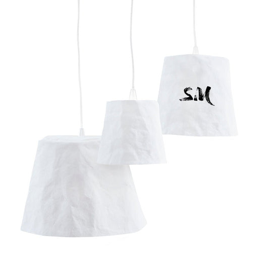 Three washable paper pendant lamps are shown hanging in varying sizes. They are white in colour. The one at right has "SM" painted on it.