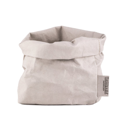 A washable paper bag is shown. The bag is rolled down at the top and features a UASHMAMA logo label on the bottom left corner. The bag pictured is the medium size in pale grey.