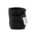 A washable paper bag is shown. The bag is rolled down at the top and features a UASHMAMA logo label on the bottom left corner. The bag pictured is the extra small size in black.