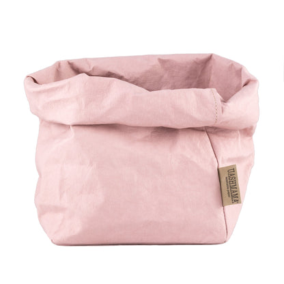 A washable paper bag is shown. The bag is rolled down at the top and features a UASHMAMA logo label on the bottom left corner. The bag pictured is the large plus size in pale pink.