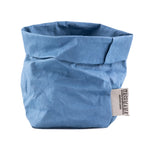 A washable paper bag is shown. The bag is rolled down at the top and features a UASHMAMA logo label on the bottom left corner. The bag pictured is the small size in light blue.