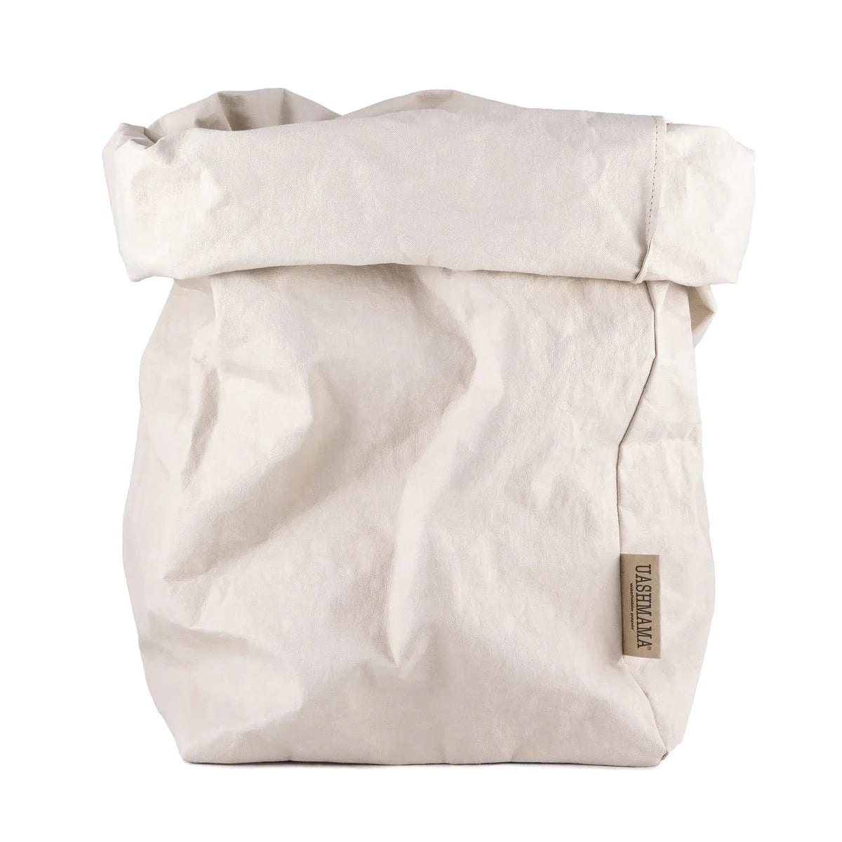 A washable paper bag is shown. The bag is rolled down at the top and features a UASHMAMA logo label on the bottom left corner. The bag pictured is the extra extra large size in a pale cream colour.