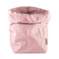 A washable paper bag is shown. The bag is rolled down at the top and features a UASHMAMA logo label on the bottom left corner. The bag pictured is the extra extra large size in pale pink.