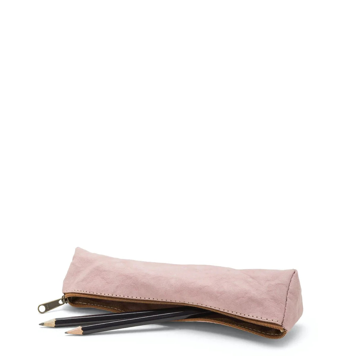A washable paper pencil case is shown on its side with two pencils spilling out. The pencil case is pale pink in colour and has a metal zip closure.