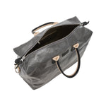 An extra large washable paper holdall is shown from above with the zip open. This shows an internal zipped pocket and organic cotton lining. The bag has two recycled cotton carry handles and a recycled cotton shoulder strap. The bag shown is dark grey.