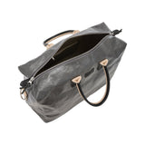 An extra large washable paper holdall is shown from above with the zip open. This shows an internal zipped pocket and organic cotton lining. The bag has two recycled cotton carry handles and a recycled cotton shoulder strap. The bag shown is dark grey.