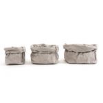 A small, medium and large paper bag in pale grey are lined up in size order from small to large.