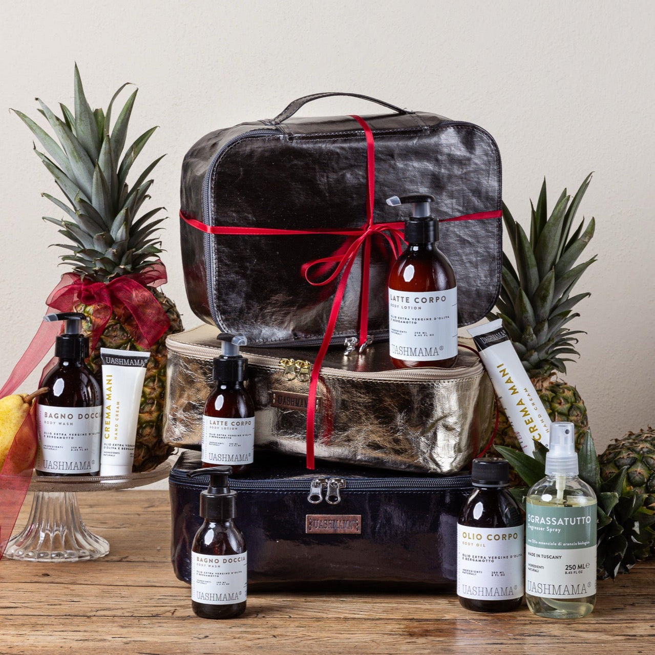 Gift basket with bottles and a pineapple on a wooden surface
