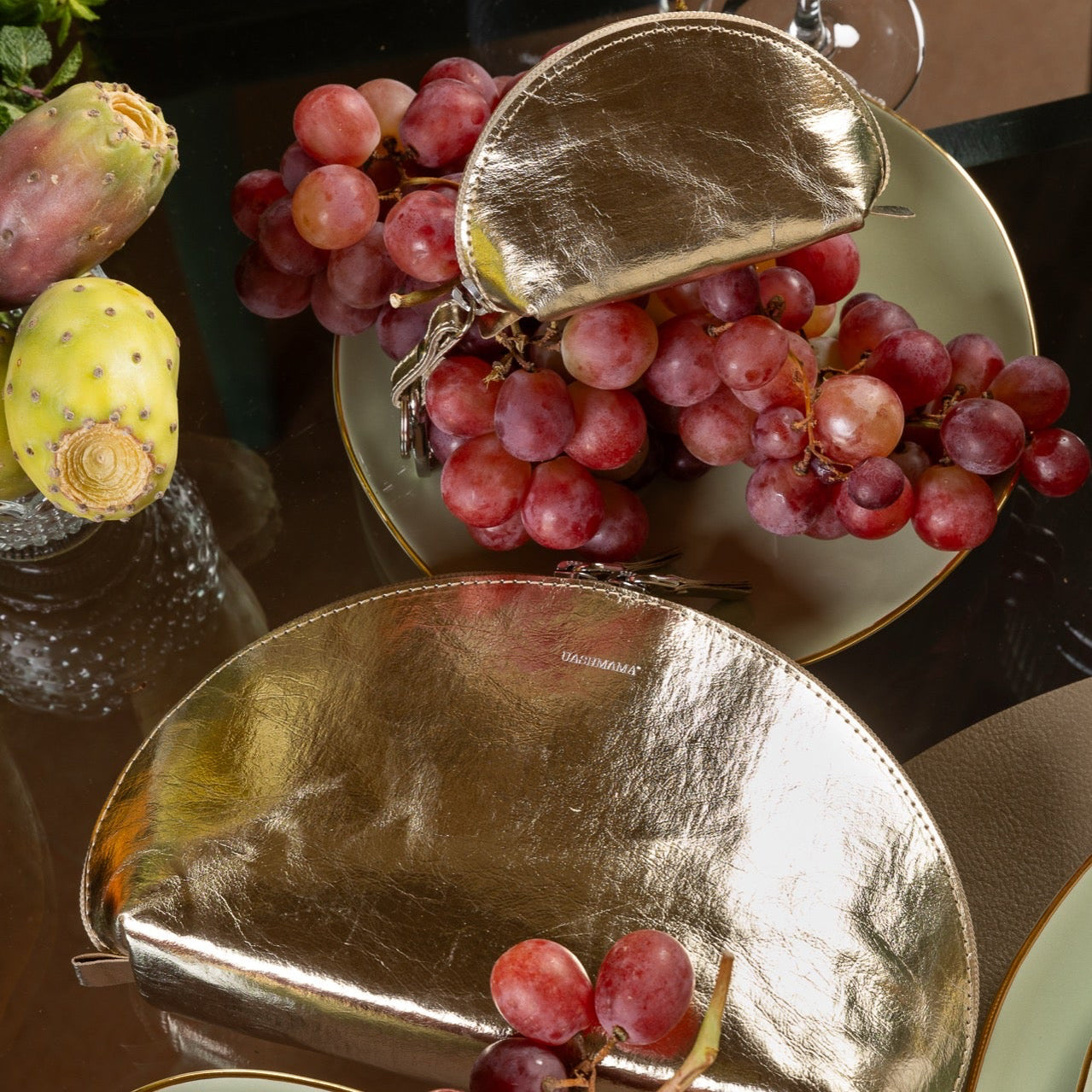 Gold metallic pouches on a plate with red grapes