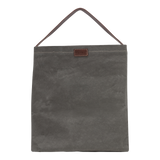 A grey washable paper handbag is shown from the front. It features a singular top handle in chocolate brown, and a brown UASHMAMA logo stamp on the front.