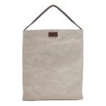 A cream washable paper handbag is shown from the front. It features a singular top handle in chocolate brown, and a brown UASHMAMA logo stamp on the front.