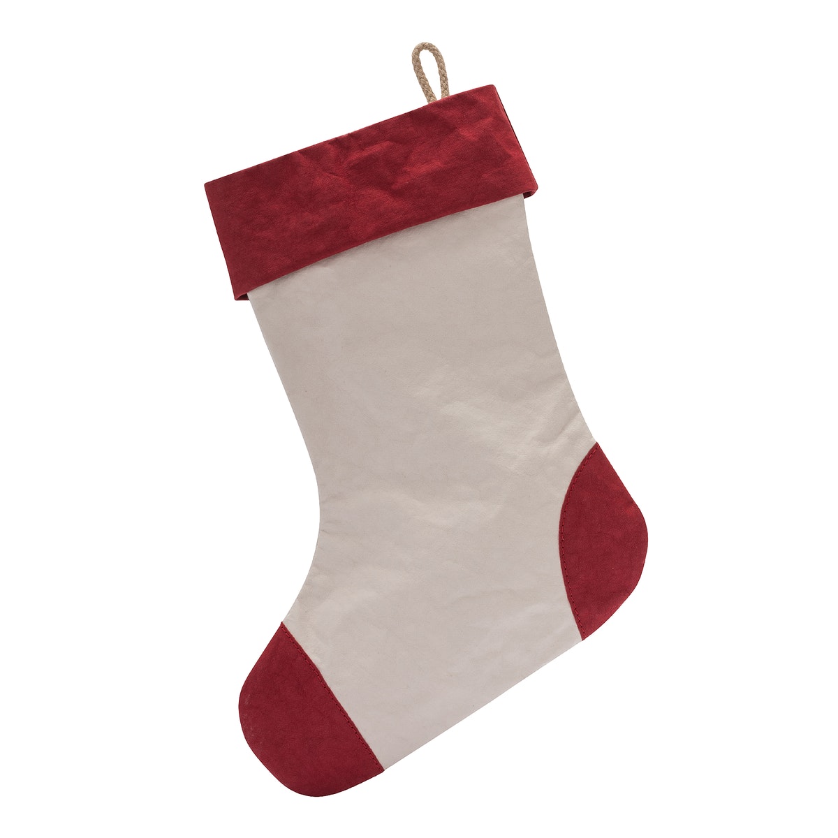 A washable paper Christmas stocking is shown. The body of the stocking is pale cream in colour. There is a fabric hanging loop on the back of the stocking at the top. The cuff, heel and toe of the stocking are red.