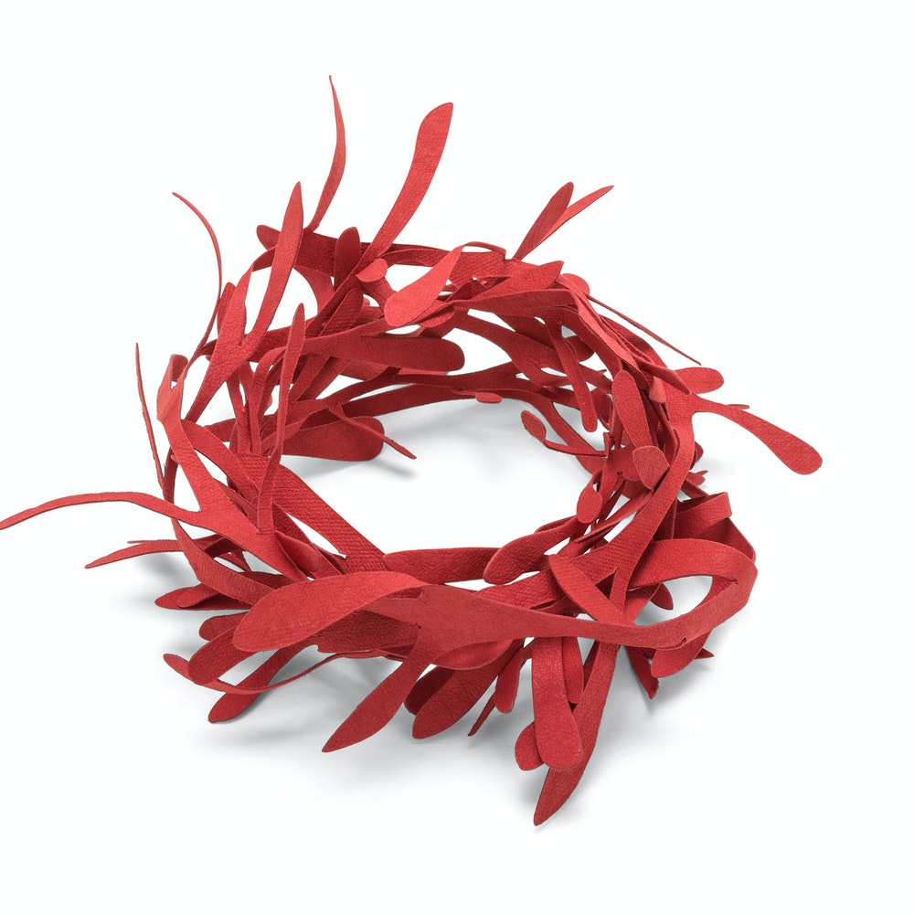 A washable paper garland wreath is shown in red.