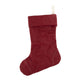 A washable paper Christmas stocking is shown. The stocking is red in colour. There is a fabric hanging loop on the back of the stocking at the top.