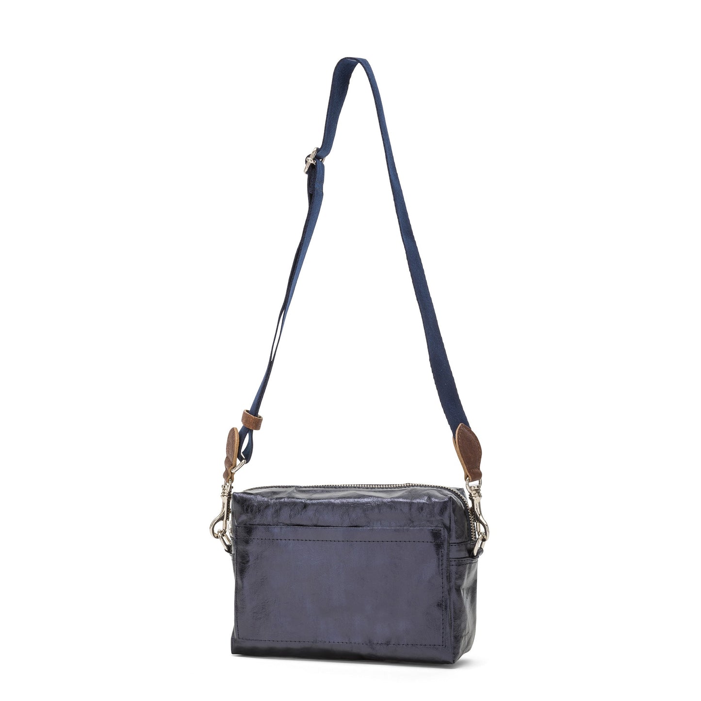 A rectangular washable paper handbag with an external side pocket is shown. The bag has a canvas strap, washable paper details and metal fastening clips to attach the straps to the bag. The bag closes by a zip. The bag shown is metallic navy with a navy strap.