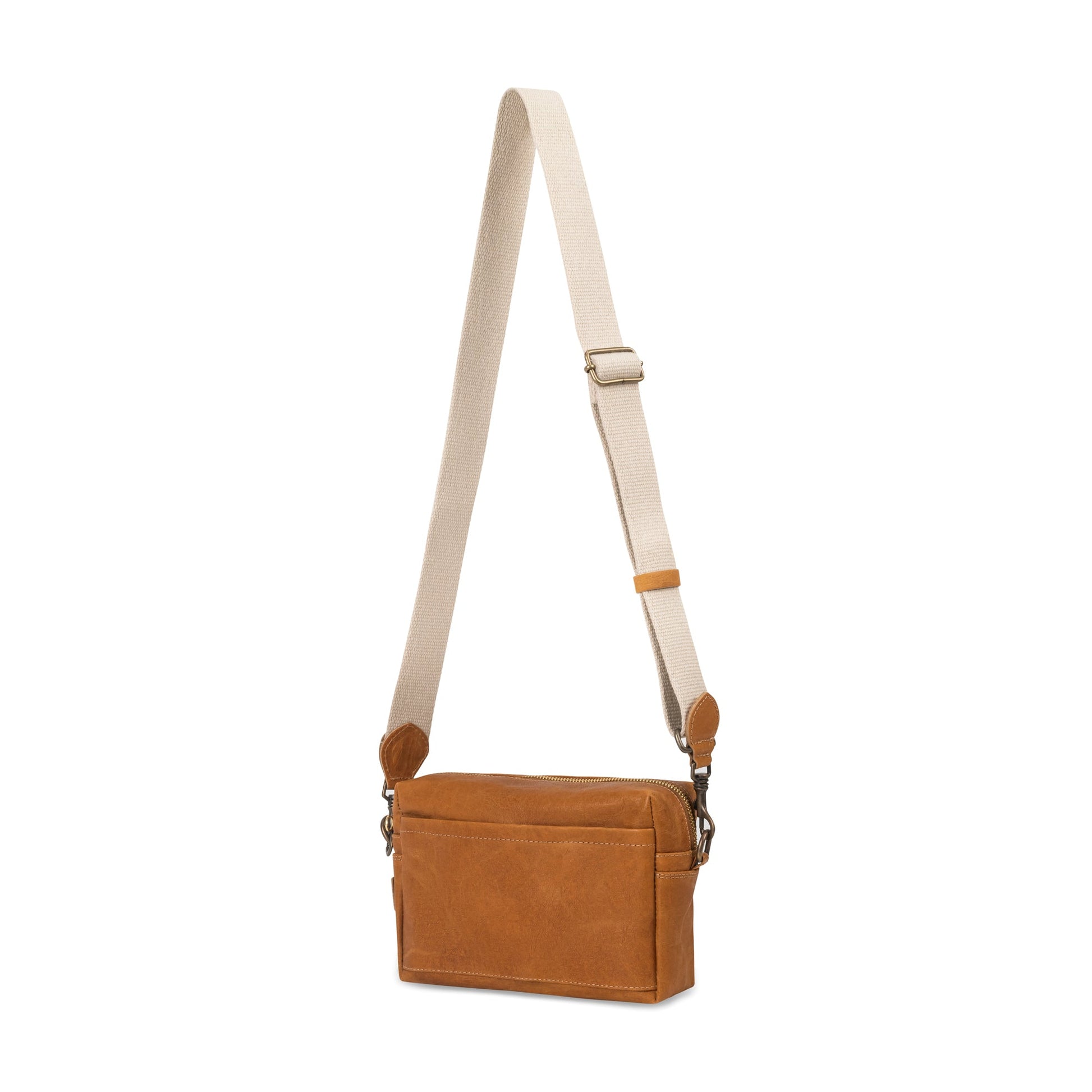 A rectangular washable paper handbag with an external side pocket is shown. The bag has a canvas strap, washable paper details and metal fastening clips to attach the straps to the bag. The bag closes by a zip. The bag shown is tan with a wheat strap.