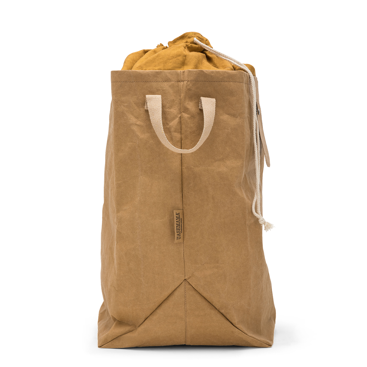 A washable paper laundry bag is shown in tan from a side angle. It features two side handles, a popper tab, and an interior drawstring lining.