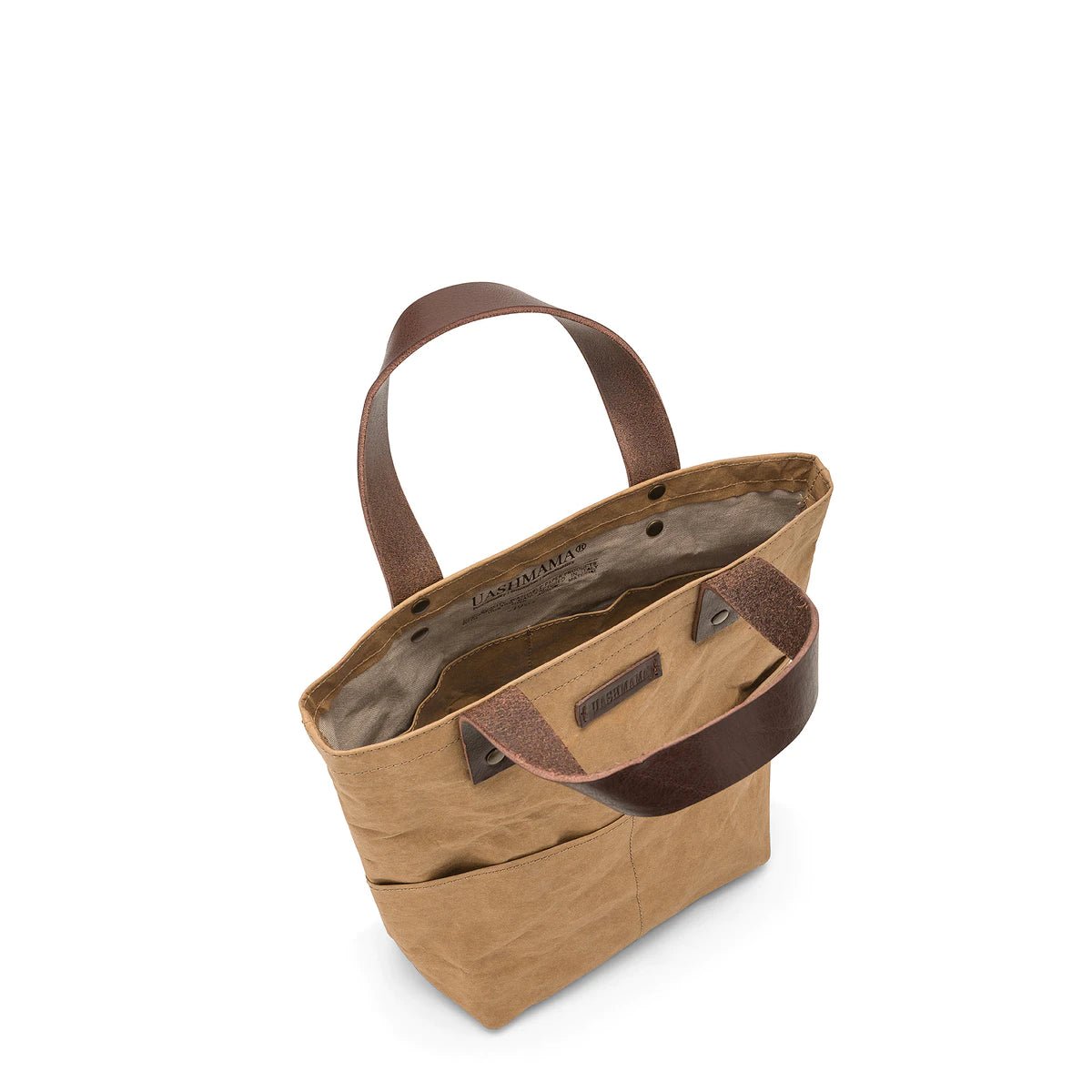 A top down view of a brown washable paper tote bag showing inside pockets and short brown leather handles