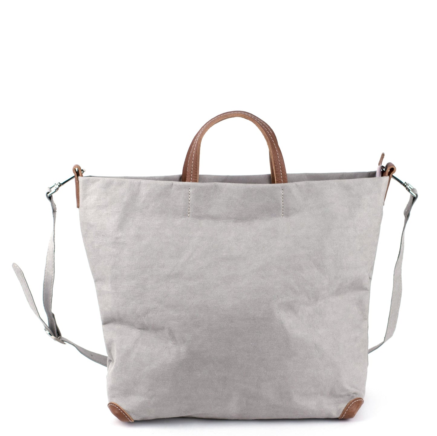 A square grey washable paper tote bag is shown with one long grey shoulder strap and two small tan handles. The corners of the bag are protected by brown corners.