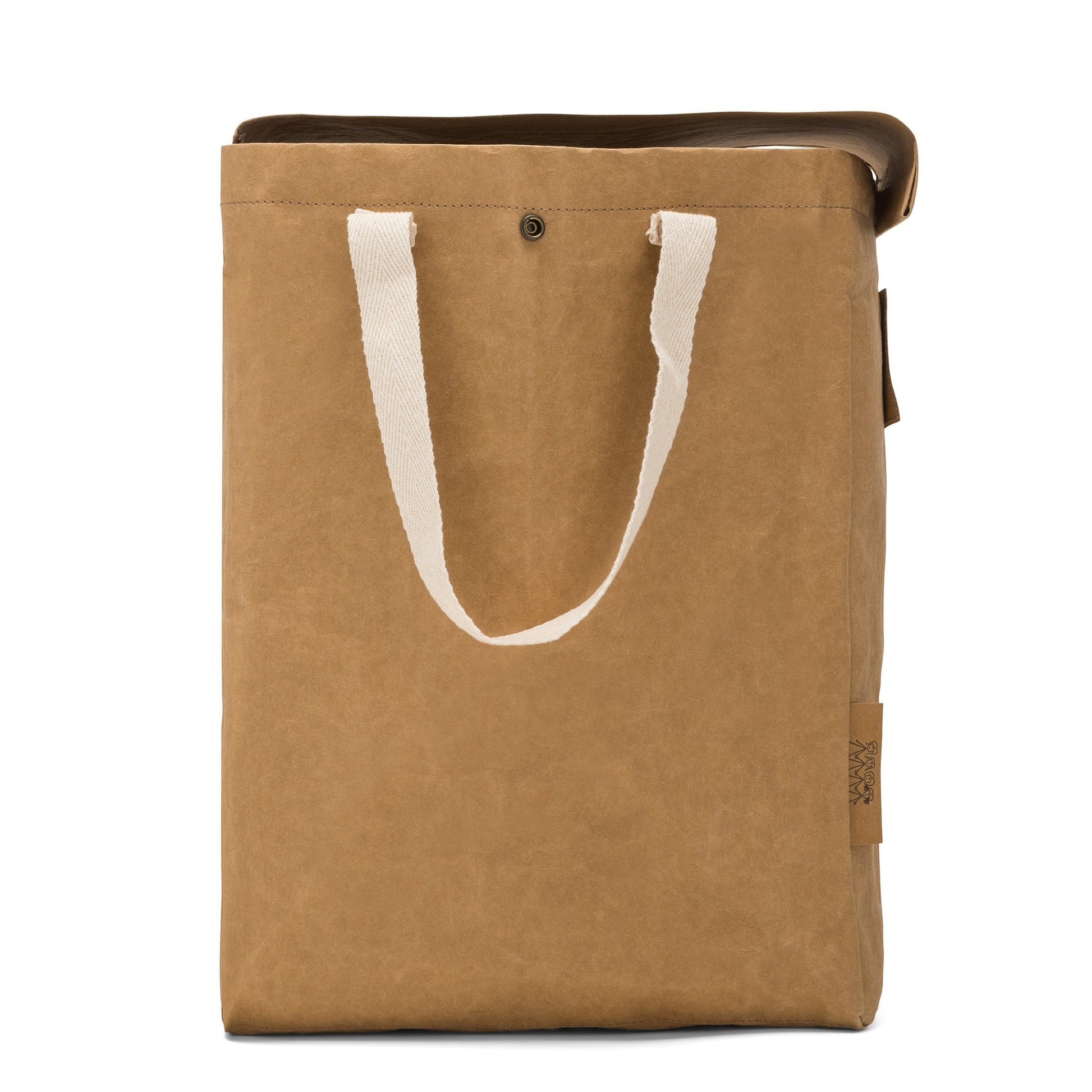 A washable paper recycling bag is shown from the side. The bag has a washable paper  lid which is attached, a washable paper tag attached to the front by two metal studs, and two recycled cotton straps - one on each side. There is a metal stud on the side at the top to attach to another washable paper recycling bag. The bag shown is tan.