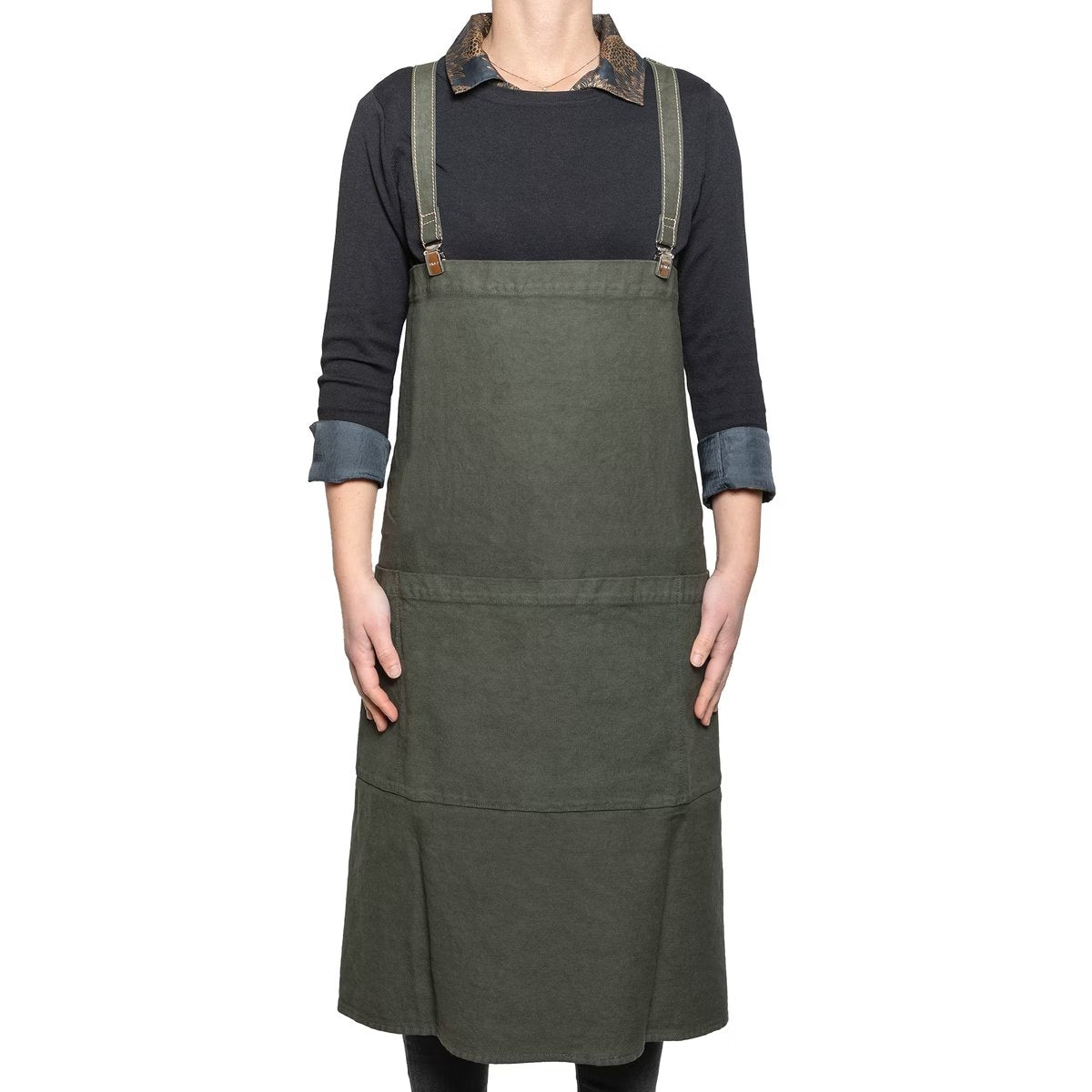 A man is shown standing wearing a dark green cotton apron with washable paper straps.