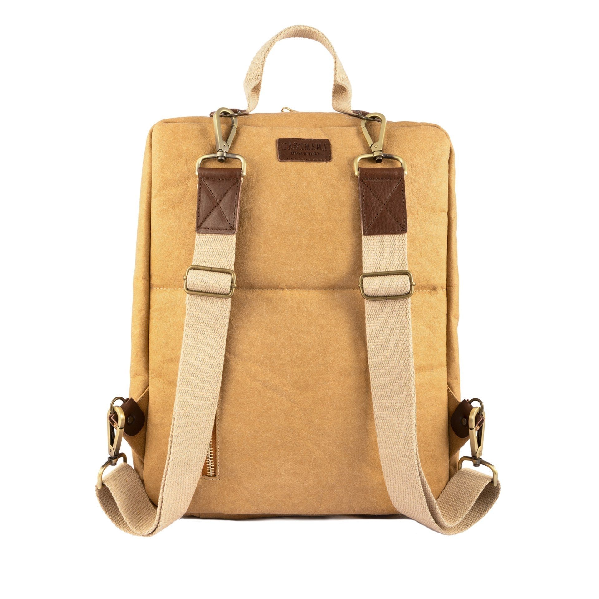 The rear of a washable paper backpack is shown. The backpack is in a light tan colour and has a top carry handle, and two recycled cotton straps. A vertical zip pocket is also shown.