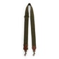 An olive bag strap is shown. The strap shows a brass adjuster, washable paper details and metal retractable fasteners.