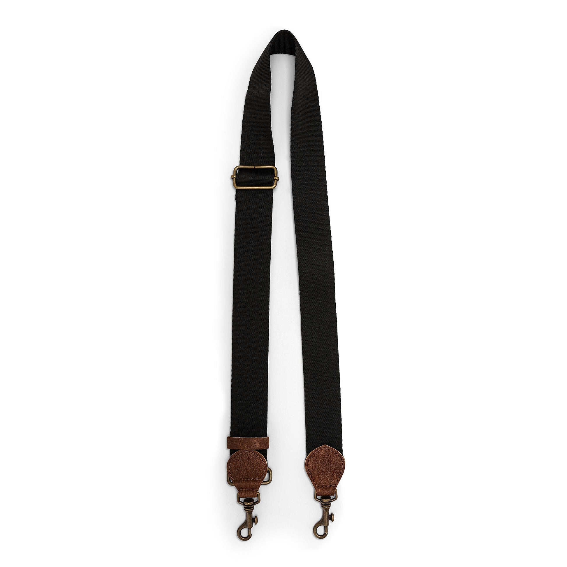 A black bag strap is shown. The strap shows a brass adjuster, washable paper details and metal retractable fasteners.