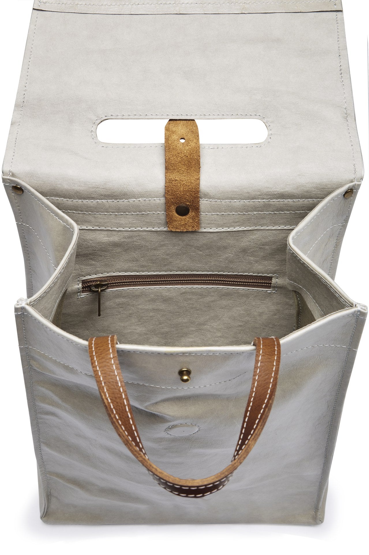A grey washable paper backpack with a tan top handle is shown open, from a top-down angle. It features an interior zip closure and a metal and paper tab closure.
