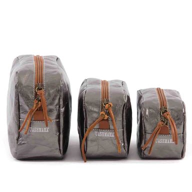 The image is of three washable paper toiletry bags, the largest is on the right, then the medium size and then the smallest size. The bags are closed and the image shows the UASHMAMA logo on the end of each bag. The bags shown are dark grey metallic in colour.