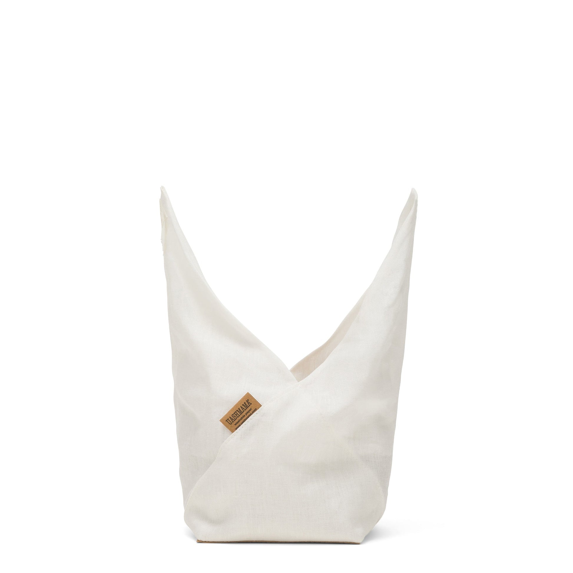 A white linen bread bag is shown with the top fully unrolled into two skyward points. A tan UASHMAMA logo tag is shown at the front.