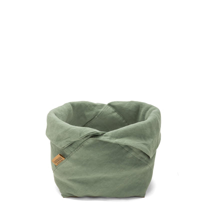 A sage green linen bread bag is shown with the top rolled down, open. A brown logo UASHMAMA tag features on the front side.