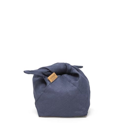 A navy linen bread bag is featured from the front, with a brown Uashmama logo tag at right. The handles are tied.