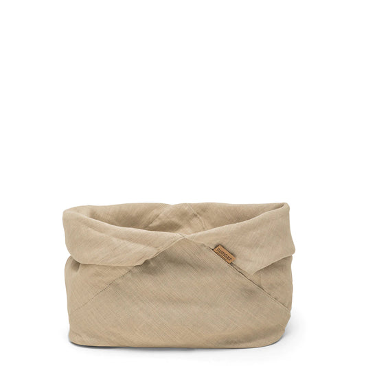 A large natural toned bread bag is shown with the top folded down into a round shape.