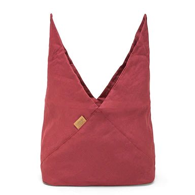 A large red linen bread bag is shown open, with the top fully unfurled, pointing skywards.