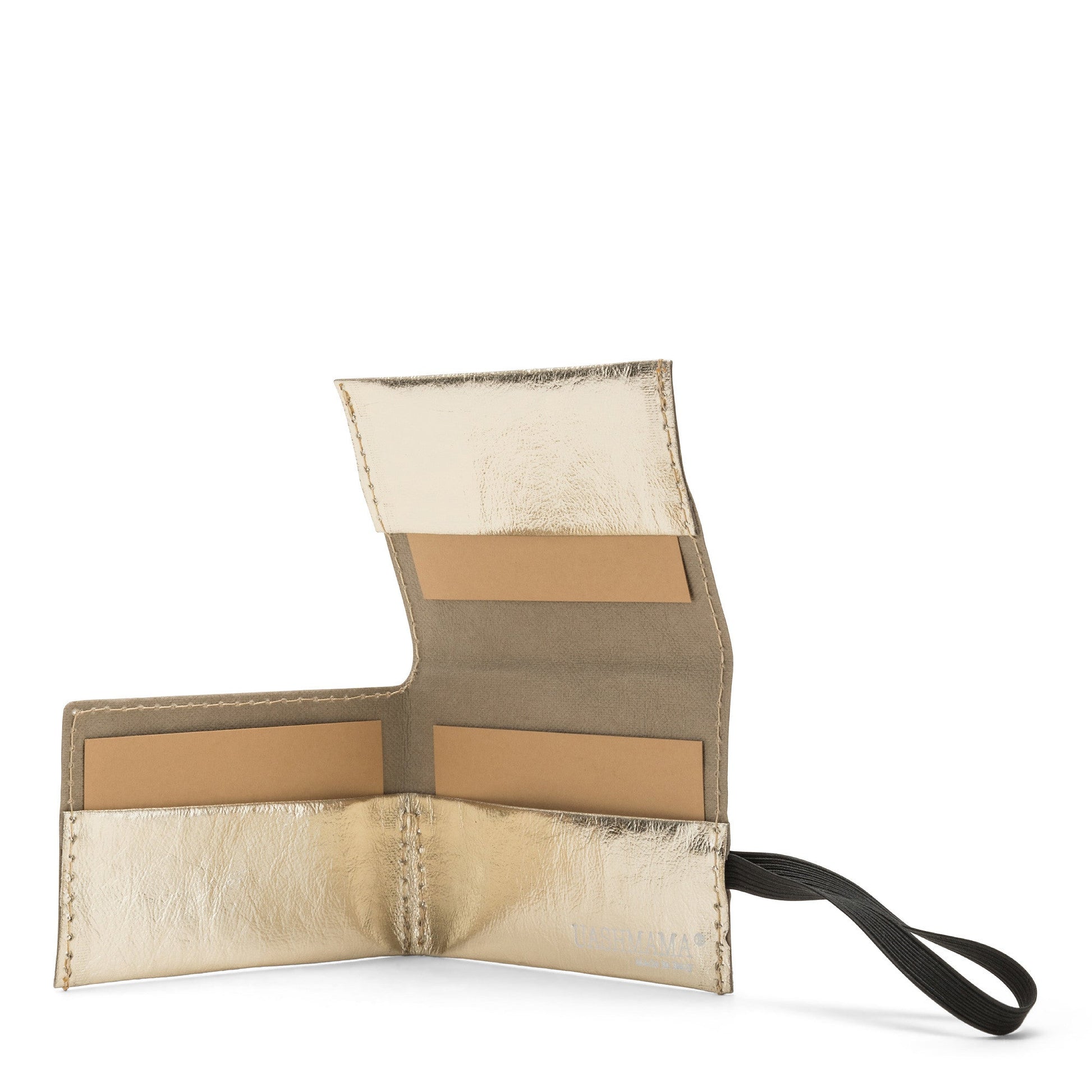 A gold metallic washable paper card holder is shown open from the front angle. It features a black elastic side strap and the white UASHMAMA logo stamped on the inside bottom right.